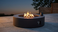Brookhurst 43 In. W X 13 In. H round Outdoor GFRC Liquid Propane Fire Pit in Carbon with Lava Rocks — Lifestyle